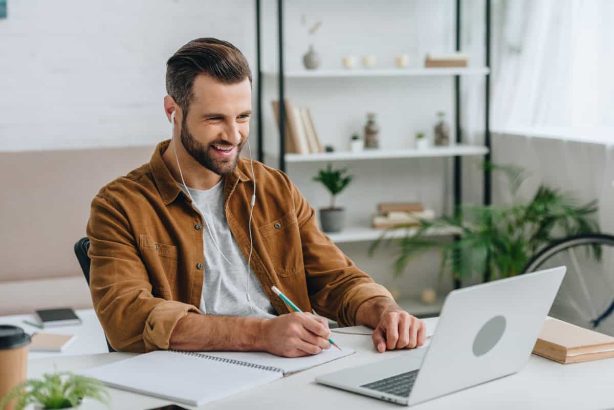 Man smiling looking at a laptop