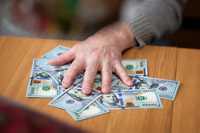 Man's hand on cash