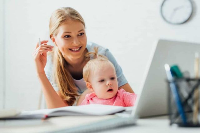 mom working with baby in lap