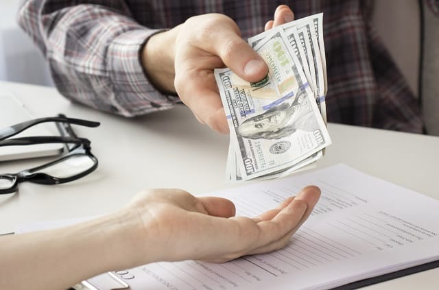 Person getting paid under the table in cash