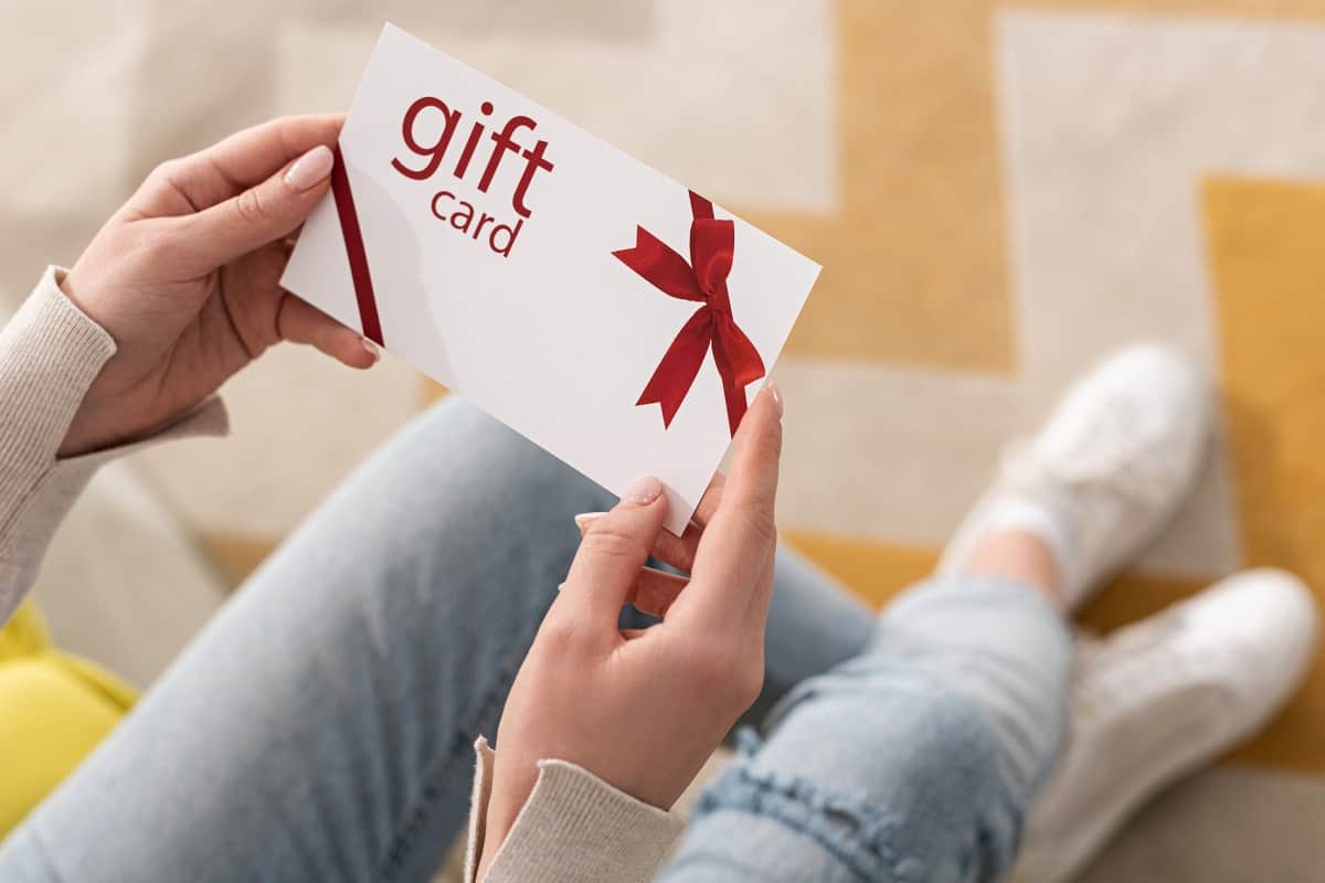 woman holding free gift card