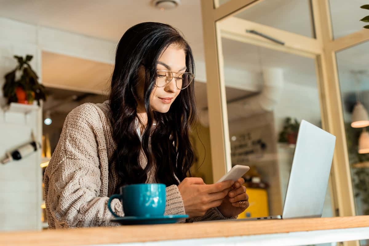 Woman researching apps that pay you to sign up on a smartphone