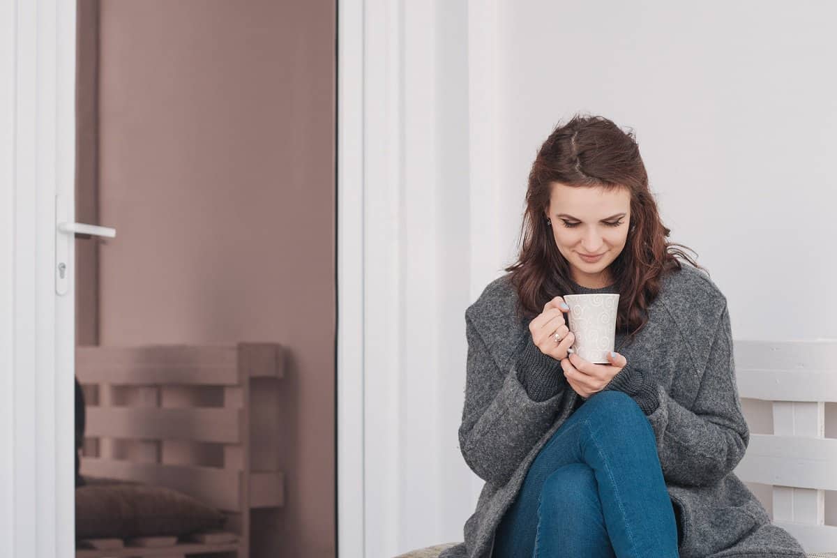 Woman smiling while drinking free Starbucks coffee