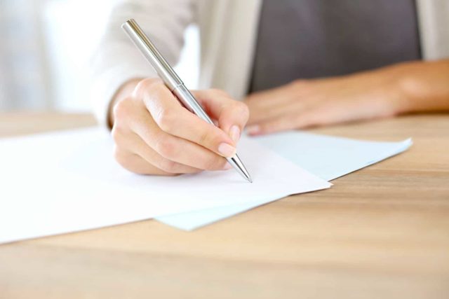 woman writing a robocall demand letter