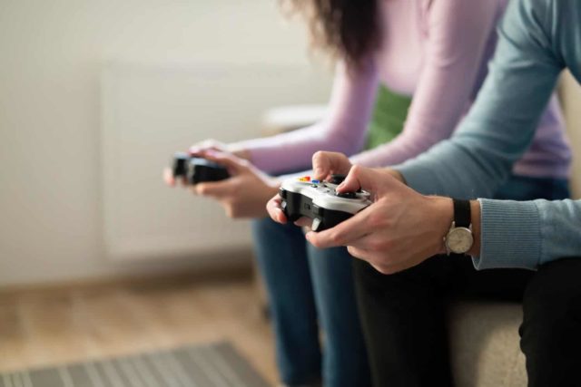 Young people playing PlayStation